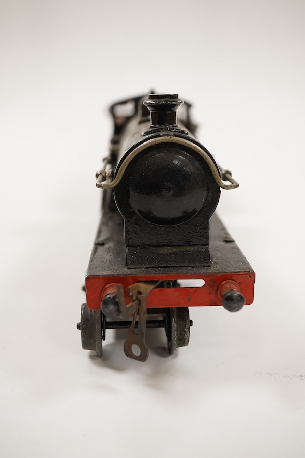 An 0 gauge Bing for Bassett-Lowke tinplate clockwork LNWR 4-4-0 tender locomotive, George the Fifth 2663, in red lined black livery with original clockwork mechanism